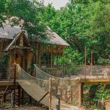 Hobbit Treehouse with waterfall on the Brazos River! 350 acres! Tubing! Petting zoo! Thumbnail