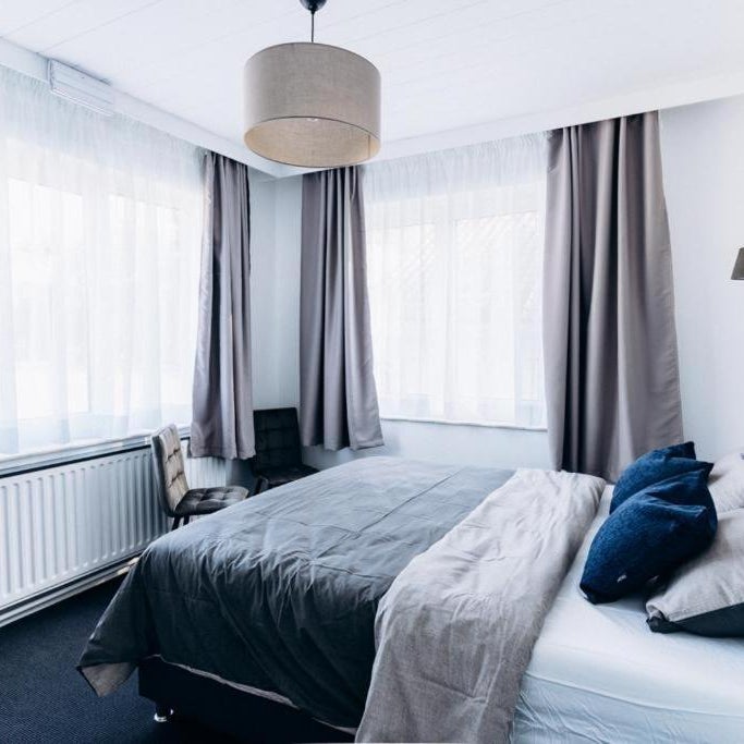 Atomihotel: Contemporary Comfort Steps from the Atomium! Thumbnail