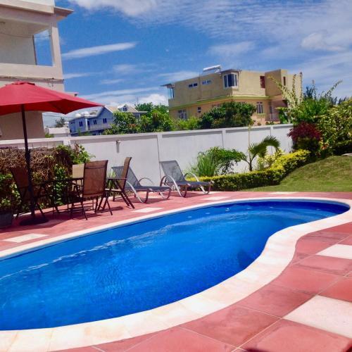 Cardamon Villa is a 2 bedroom with 1 bathroom and seperate toilet detached house with AC and swimming pool , 5 minutes walk from Flic en Flac public beach Thumbnail