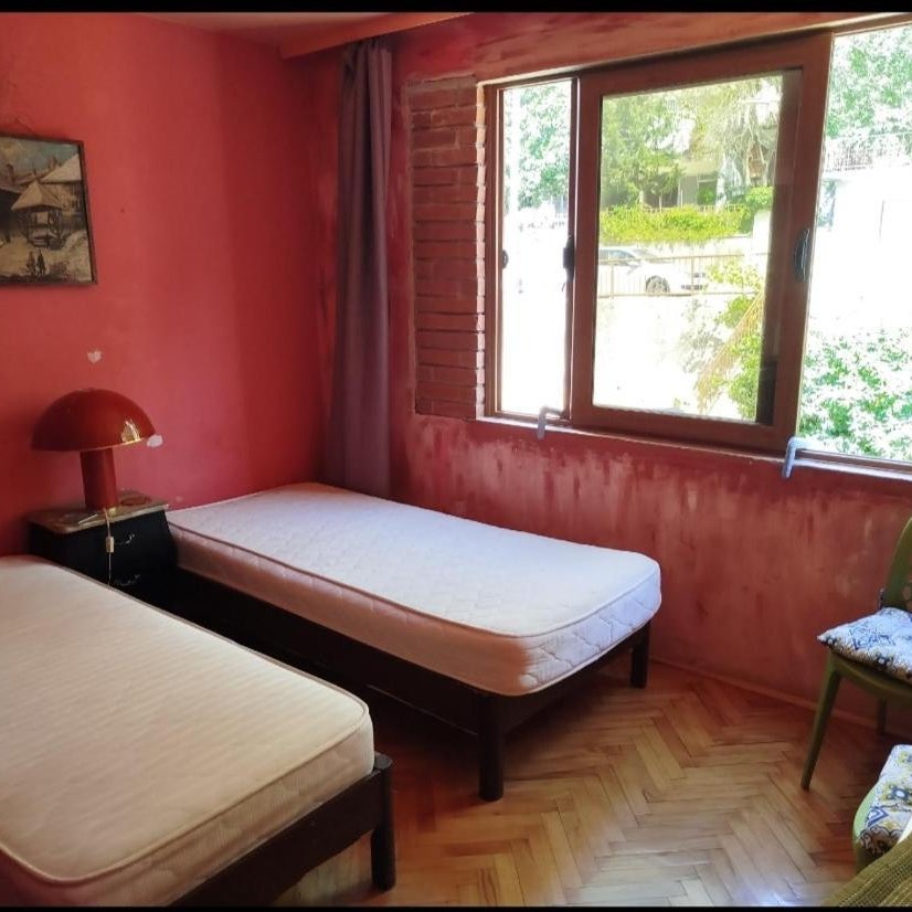 Room with two beds and shared bathroom